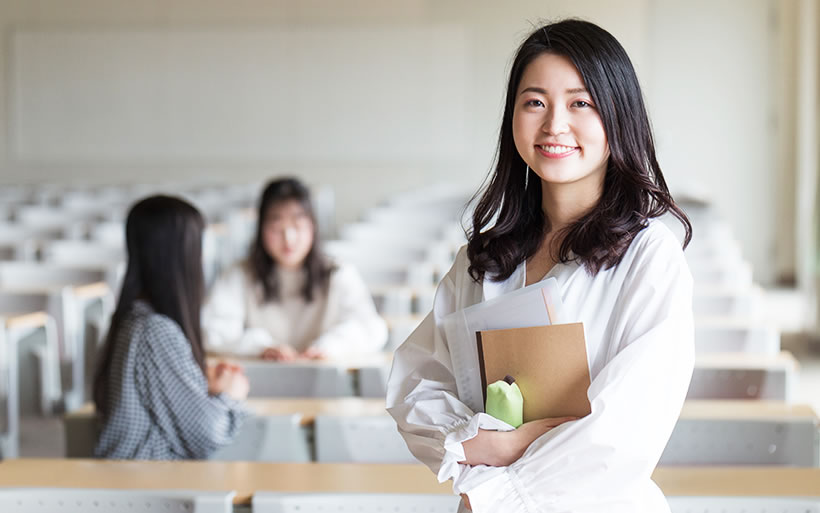 ノートと筆箱を持つ女性